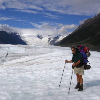 Hiker crossing Root Glacier in Wrangell St. Elias National Park, Alaska