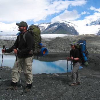 Hiking across crossing Glacier moraine in Wrangell St. Elias National Park, Alaska