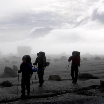 Hiking across Bremner glacier  on Seven Pass route in Wrangell St. Elias National Park, Alaska