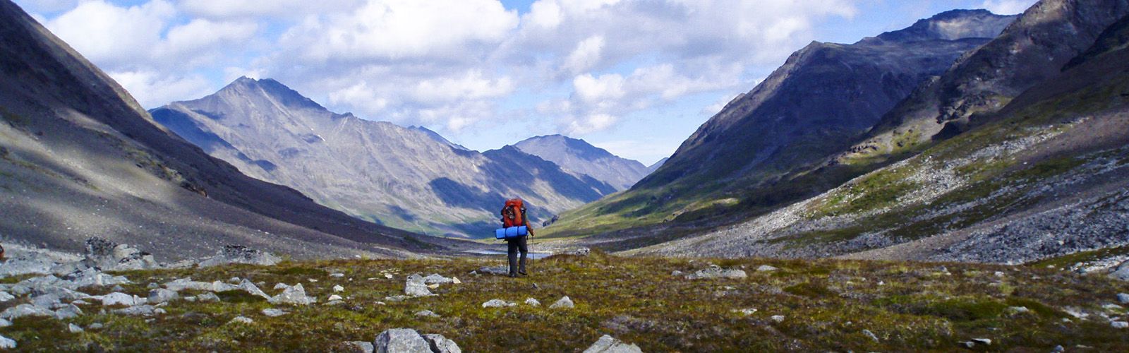 Backpacking over pass on Seven Pass route in Wrangell St. Elias National Park, Alaska